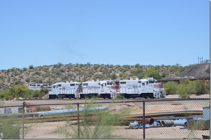 The ASARCO smelter is on the hill side behind the community of Hayden. The line crosses the highway and starts up a steep grade just east of the Hayden Jct. yard. CBRY 501-304-402 switch ore concentrate loads behind ex-Rock Island GP18s 203-201-202. CBRY 501-304-402 203. Hayden AZ.